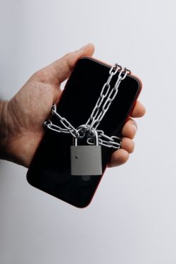 Modern,Smartphone,With,Chain,Locked,In,Man's,Hand.,Social,Network